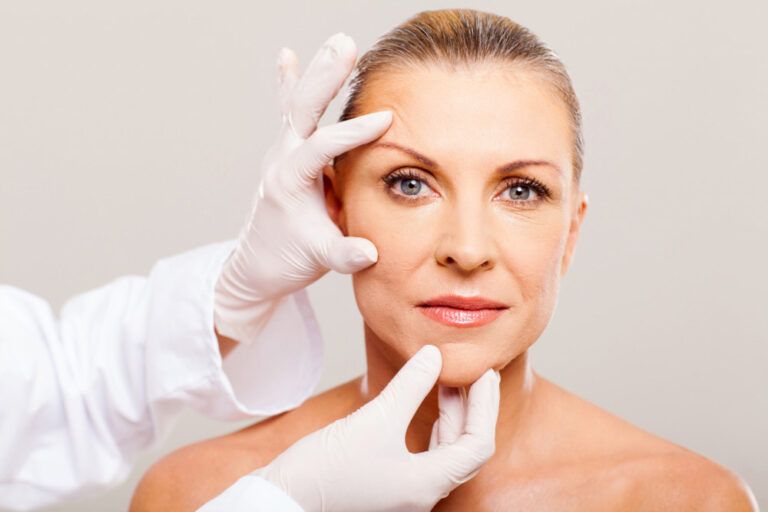 Plastic surgeon assessing brow position before brow lift surgery
