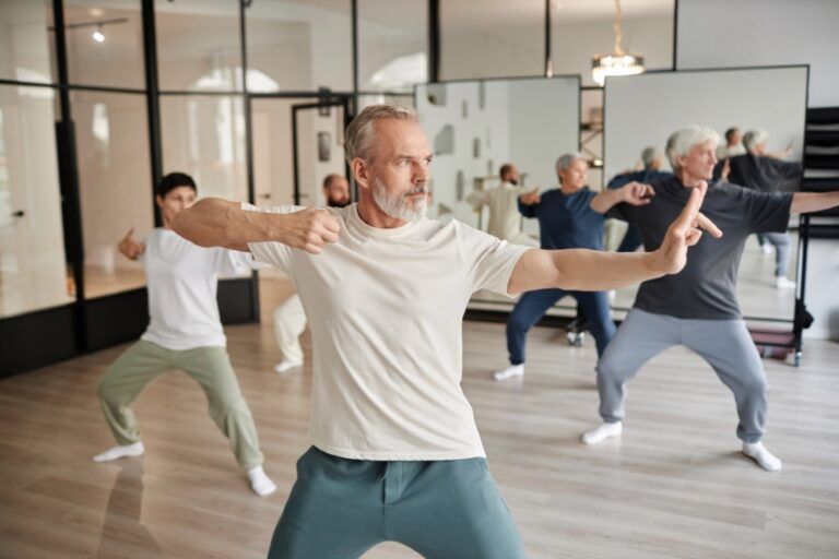 Active seniors practicing tai chi and longevity movement therapy in a modern wellness studio in Prague